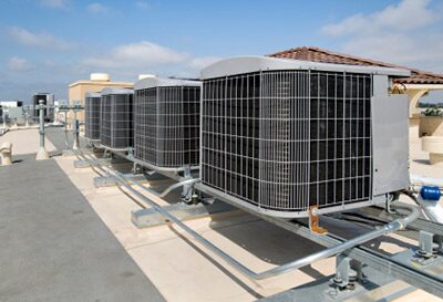 A row of rooftop condensing units on a commercial building